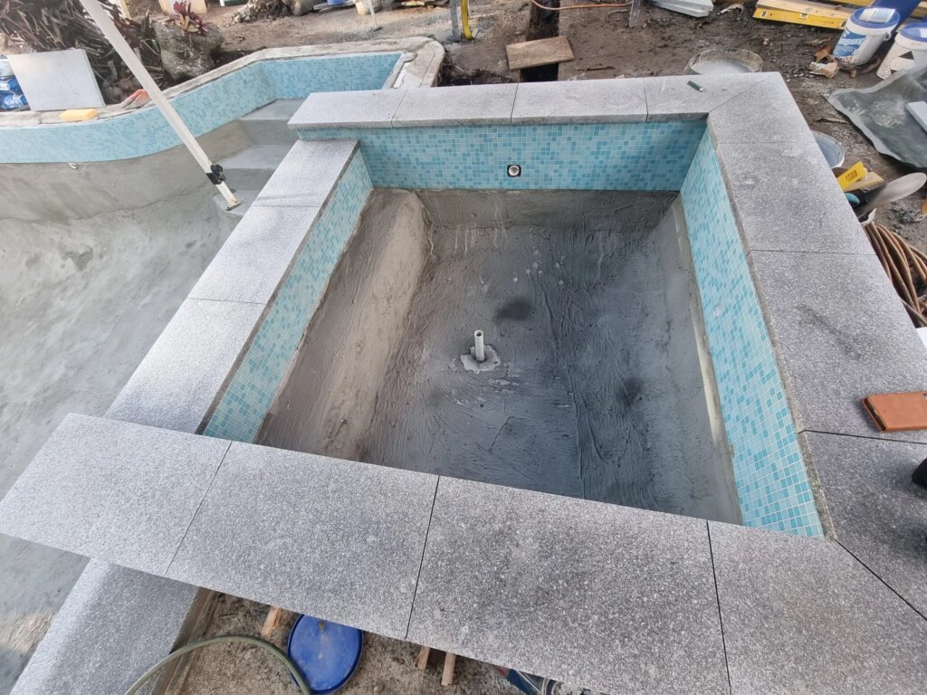 Stone pool coping and mosaic waterline tile on an Auckland pool