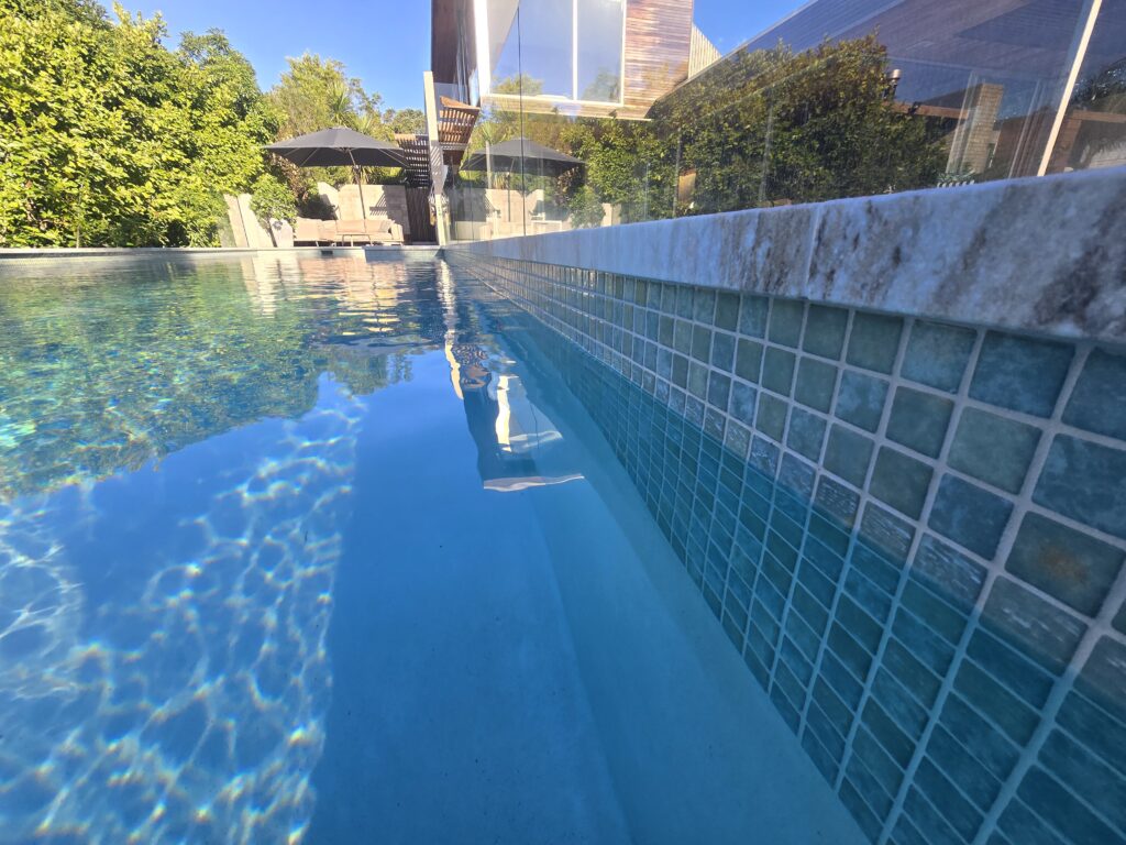 Westmere pool after renovation with new glass mosaic interior and coping, Auckland