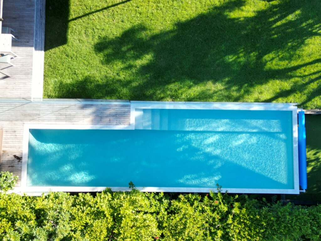 Concrete pool with glass-sided infinity spa in Westmere Auckland