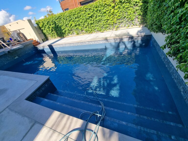 Completed concrete pool renovation in Castor Bay Auckland with porcelain coping