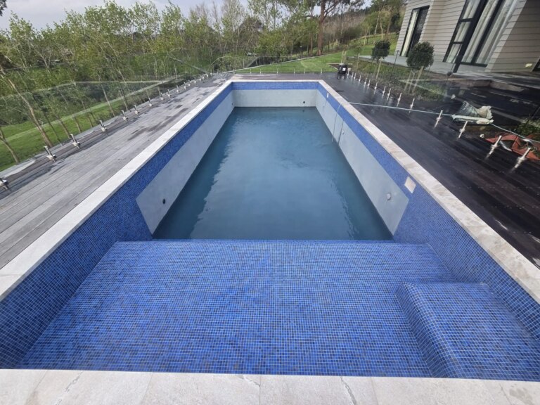 Pool renovation in Coatsville Auckland with tiled concrete sun shelf