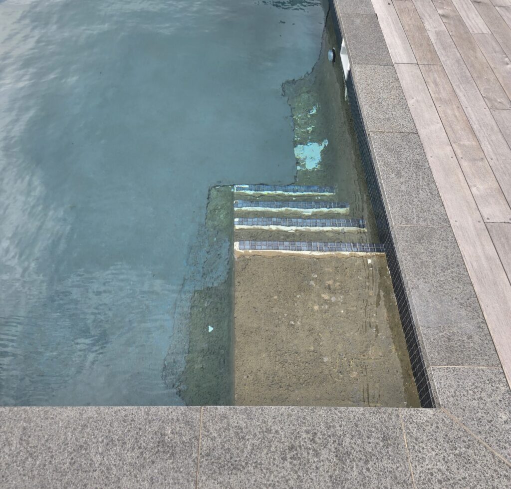 Pebblecrete surface finish on concrete pool Auckland