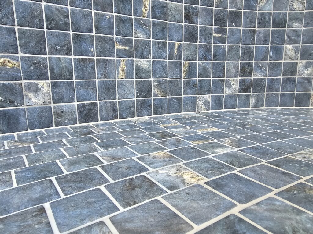Textured non-slip stone tiles in a pool wet area