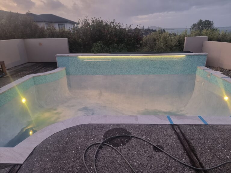Pool renovation in Howick Auckland with fully tiled stairs and feature wall