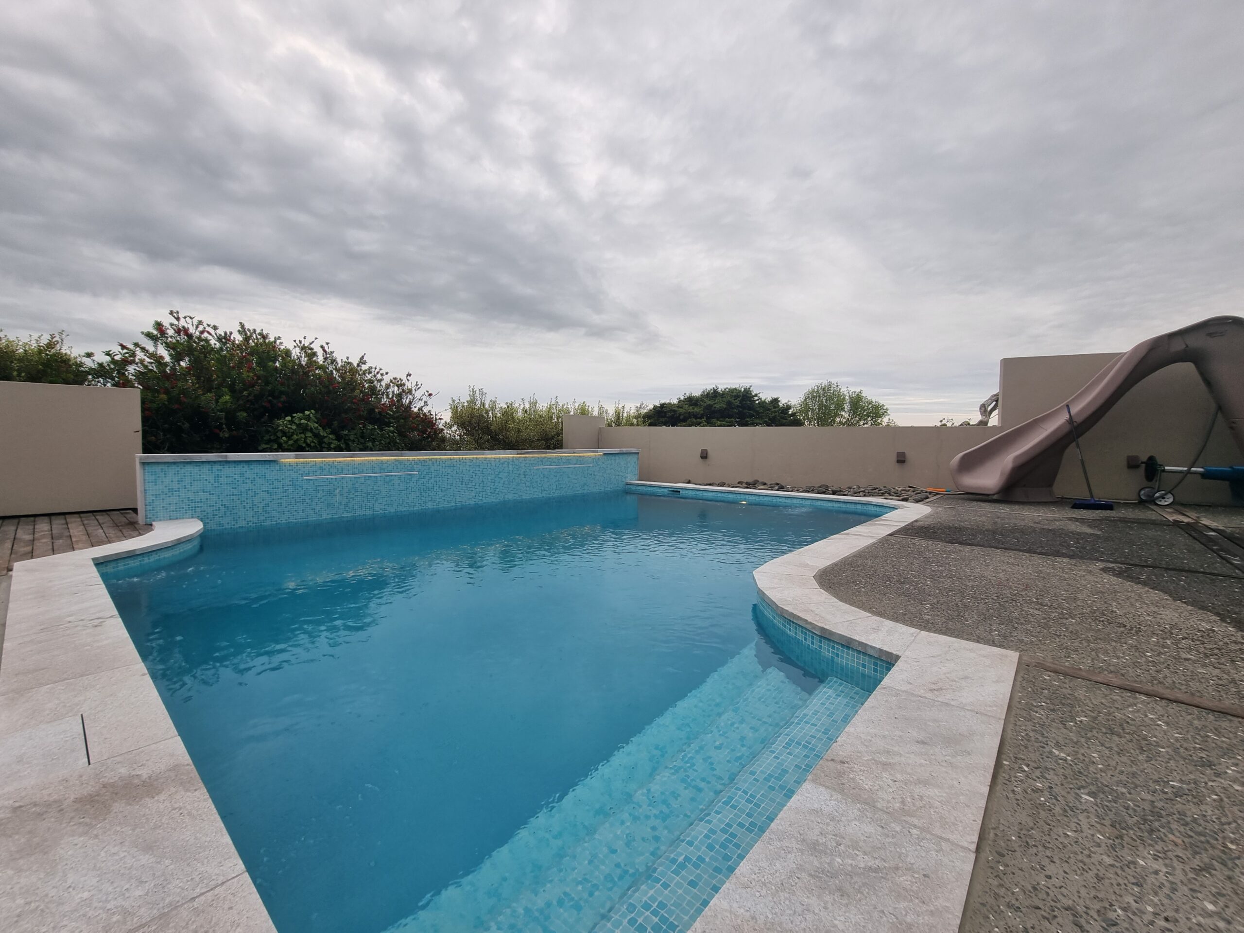 Finished tiled pool with slide in Howick Auckland