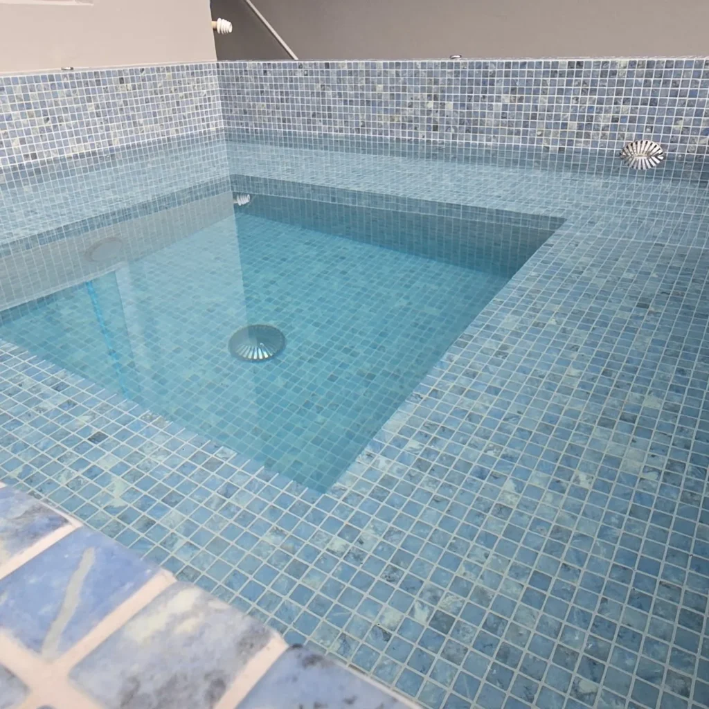 Fully tiled spa in Remuera Auckland with stainless steel fittings